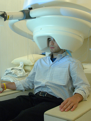 A man being scanned with an MEG machine